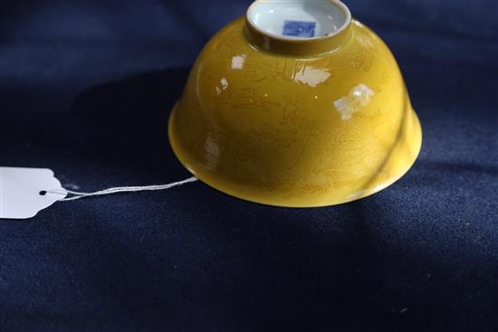 A Chinese yellow glazed sgraffito dragon bowl, Qianlong seal mark and of the period (1736-95), Diam.13.3cm, restored